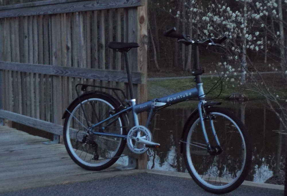 Dyan folding bike standing on bridge sunset