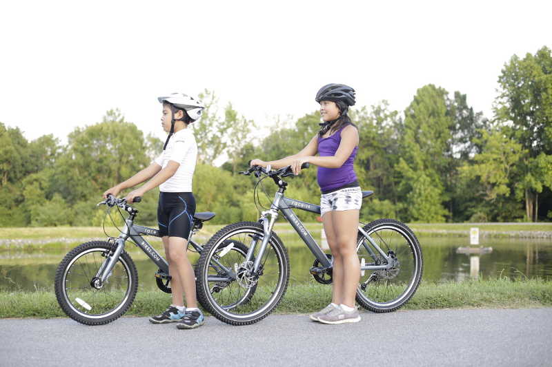 boy and girl with mountain bikes